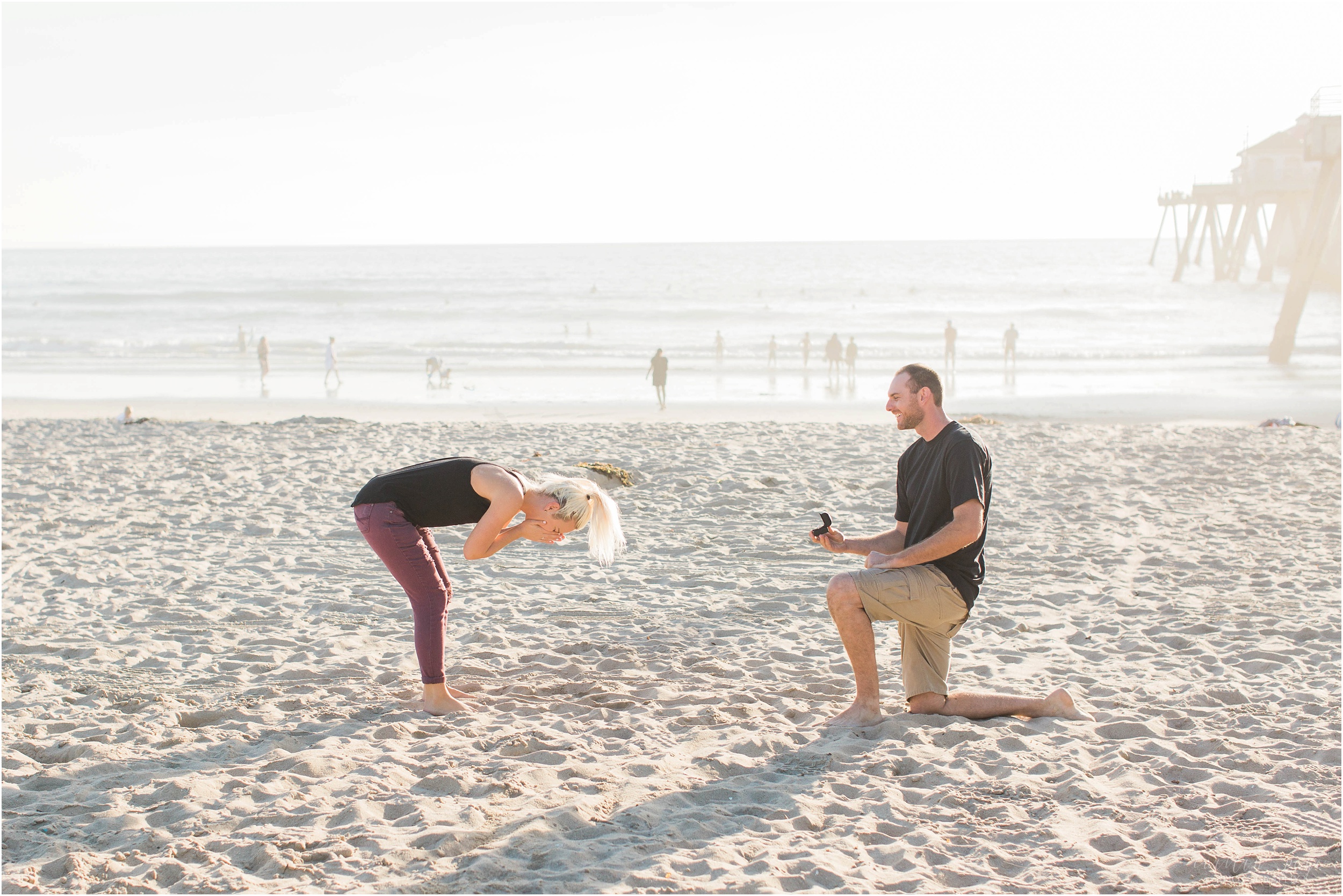 man proposing to woman on beach california
