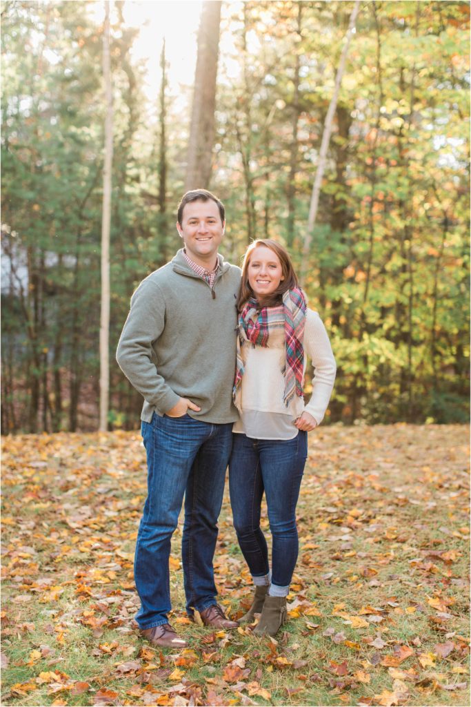 man and woman standing in leaves