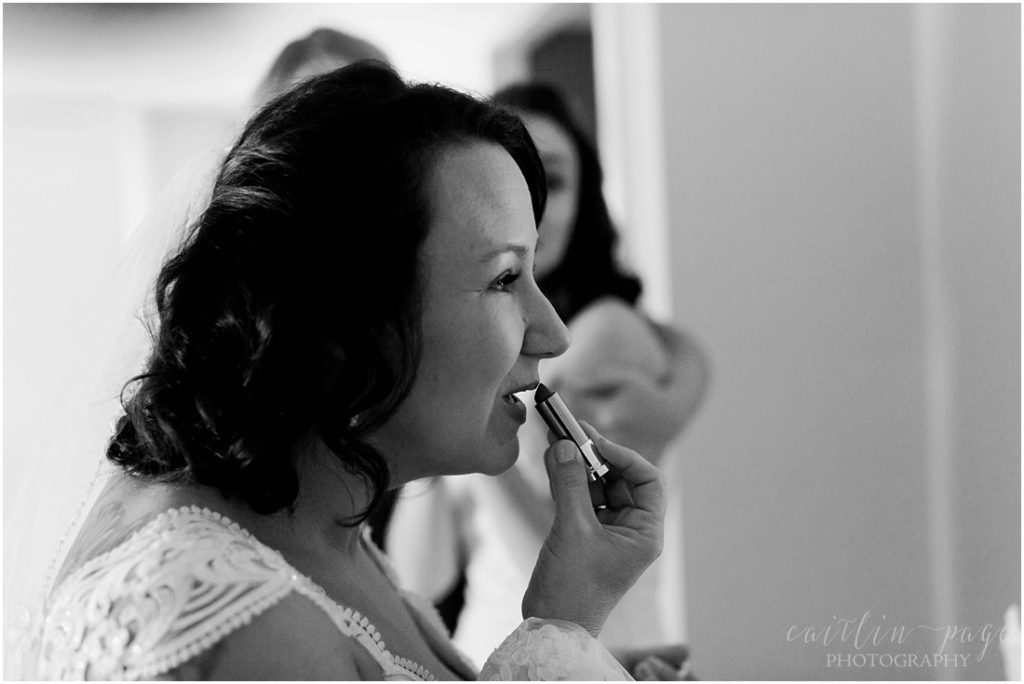 Bride applying lipstick