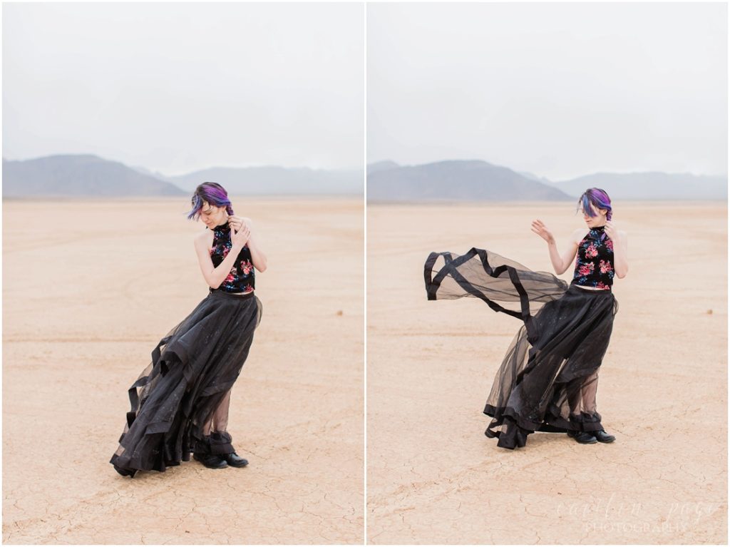 Girl with purple hair and flowy black skirt in desert