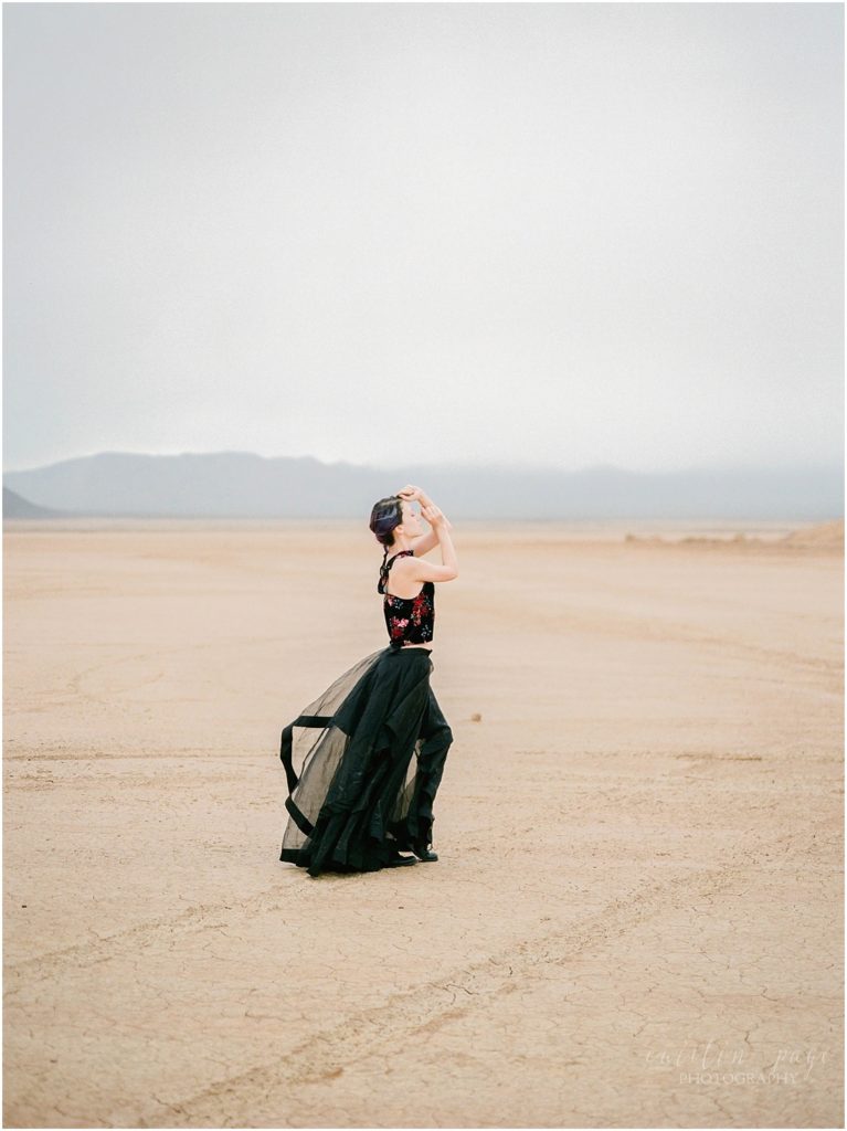 Film shot of girl modeling in the desert with black skirt