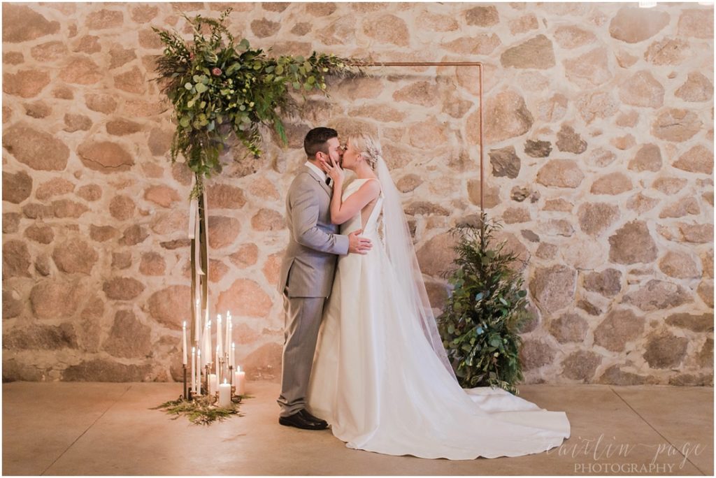bride-and-groom-in-stone-barn-wedding-ceremony