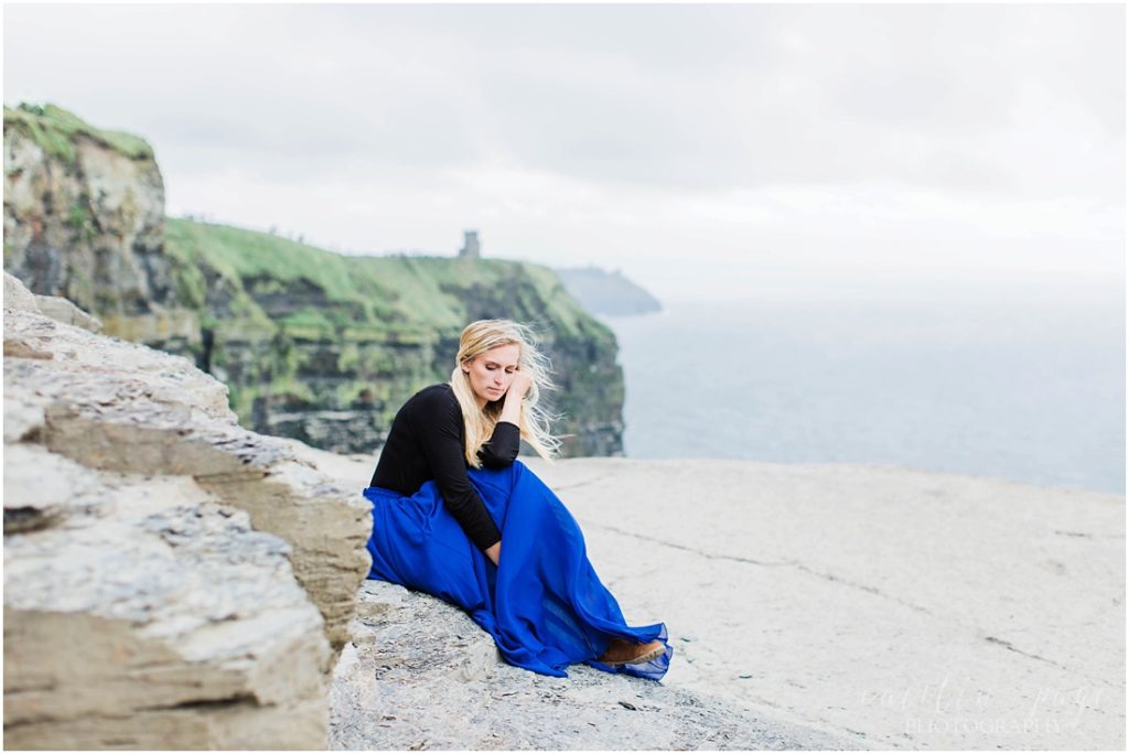 girl sitting at cliffs of moher