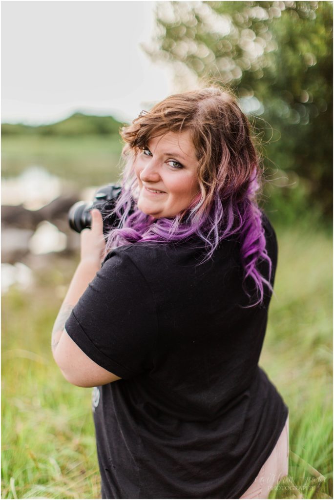 girl with purple hair holding camera