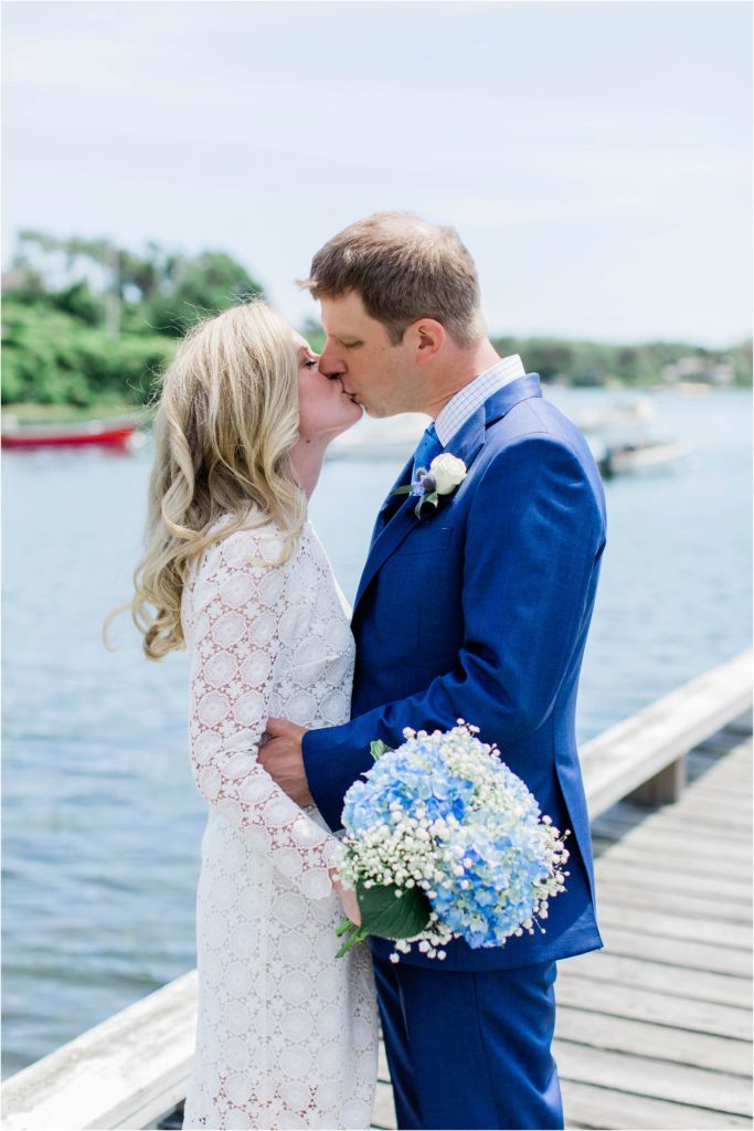 bride and groom kissing with hydrangea bouquet