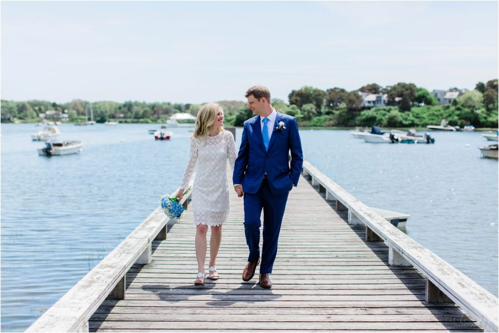 bride and groom walking down a dock