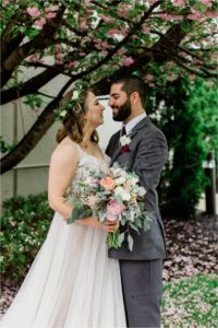 bride and groom together under tree