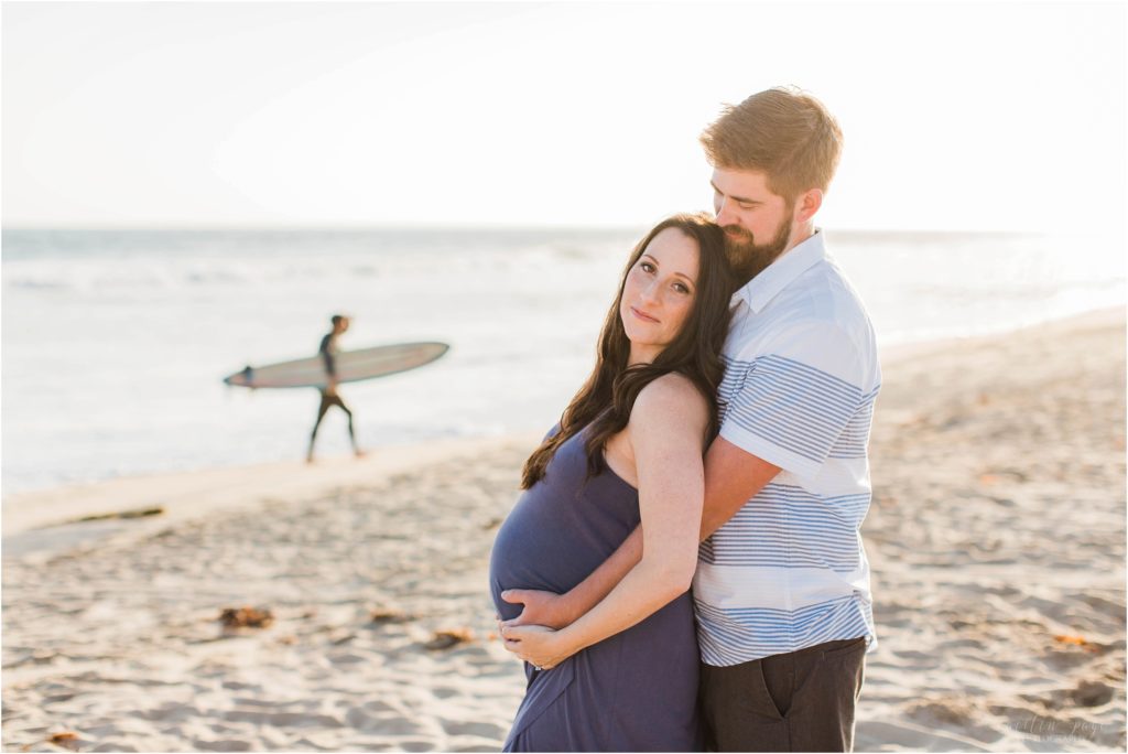 pregnant mom and dad with surfer