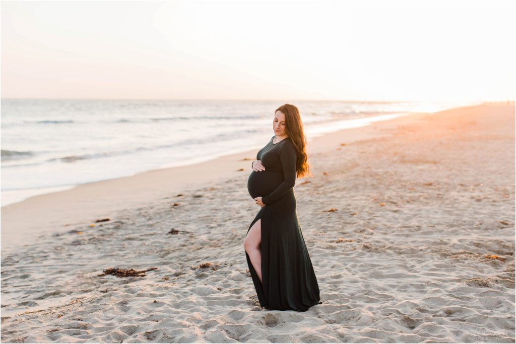 pregnant woman at sunset on beach