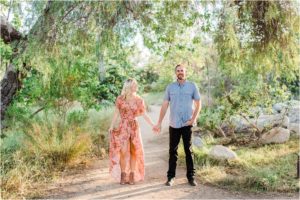 man and woman standing under eucalyptus tree