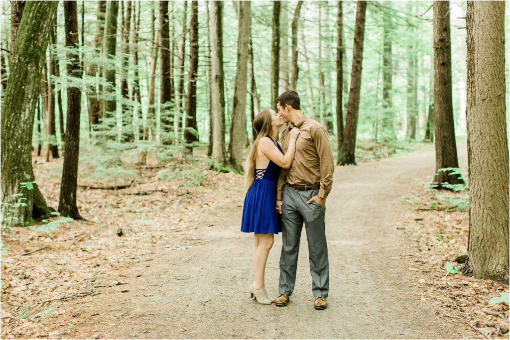 couple kissing in woods