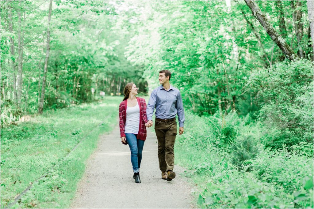 man and woman walking on trail