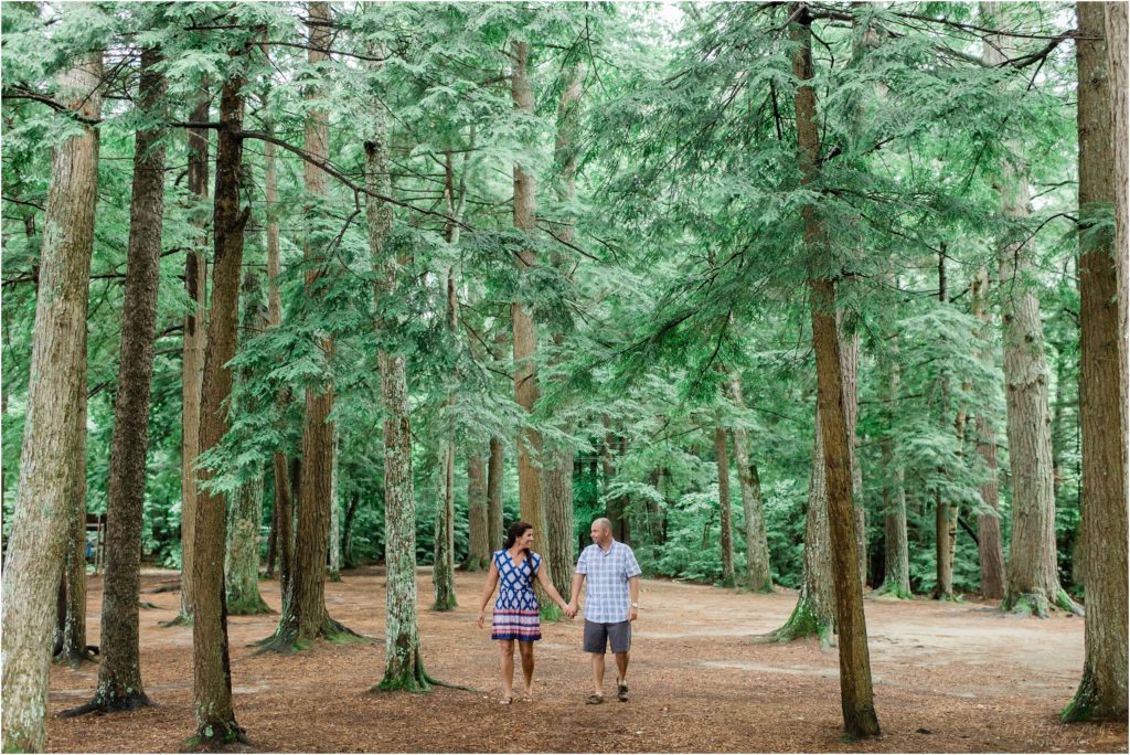 man and woman walking in the woods