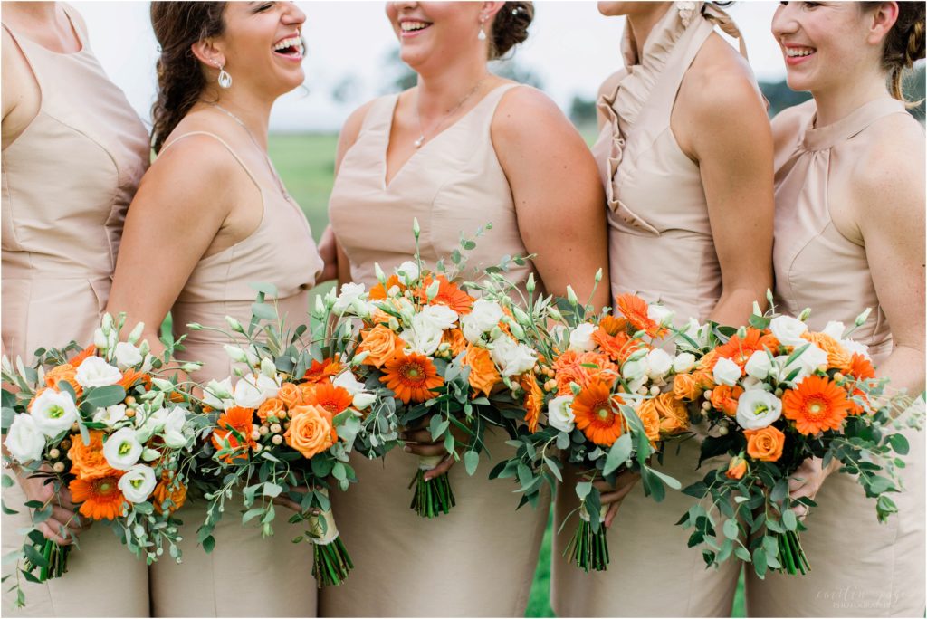 bridesmaids and orange bouquets