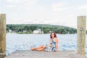 senior girl sitting on dock town docks meredith new hampshire