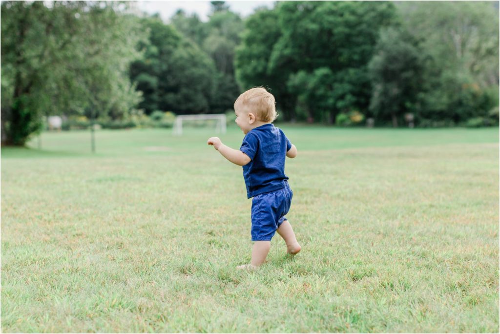 toddler boy running away field