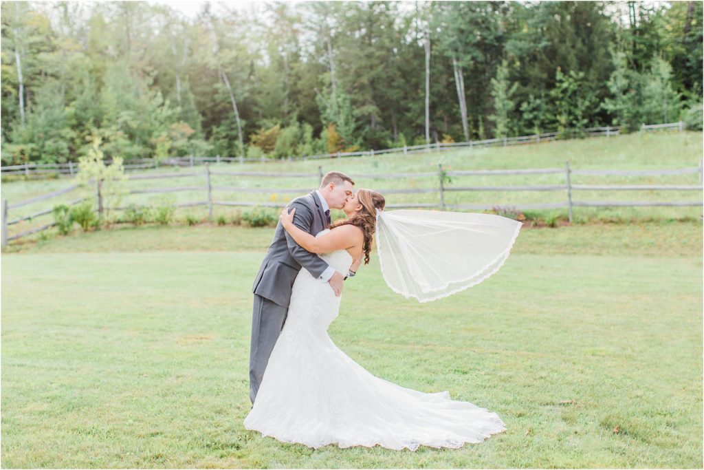 bride and groom kissing with flying veil