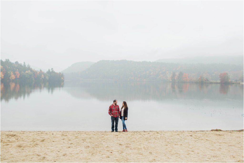 couple standing at edge of crystal lake eaton nh