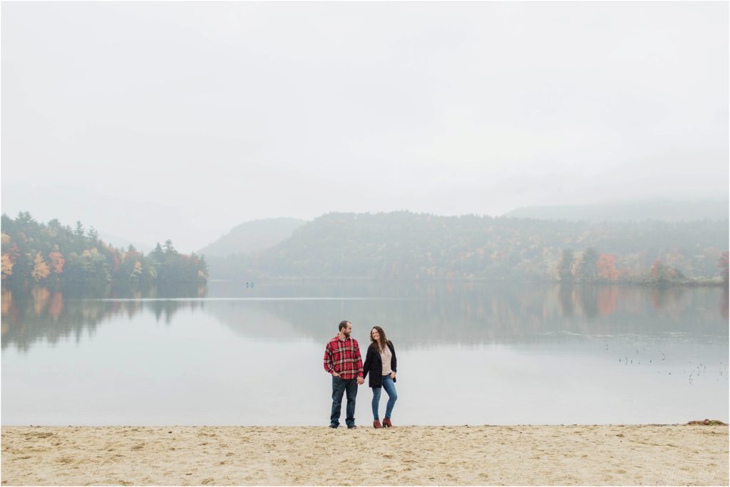 couple standing at crystal lake engagement session