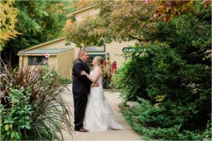 bride and groom standing in front of carriage house eagle mountain house jackson nh