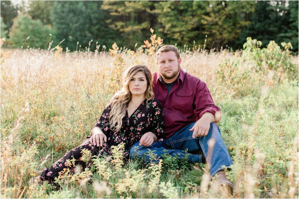 couple sitting in field together