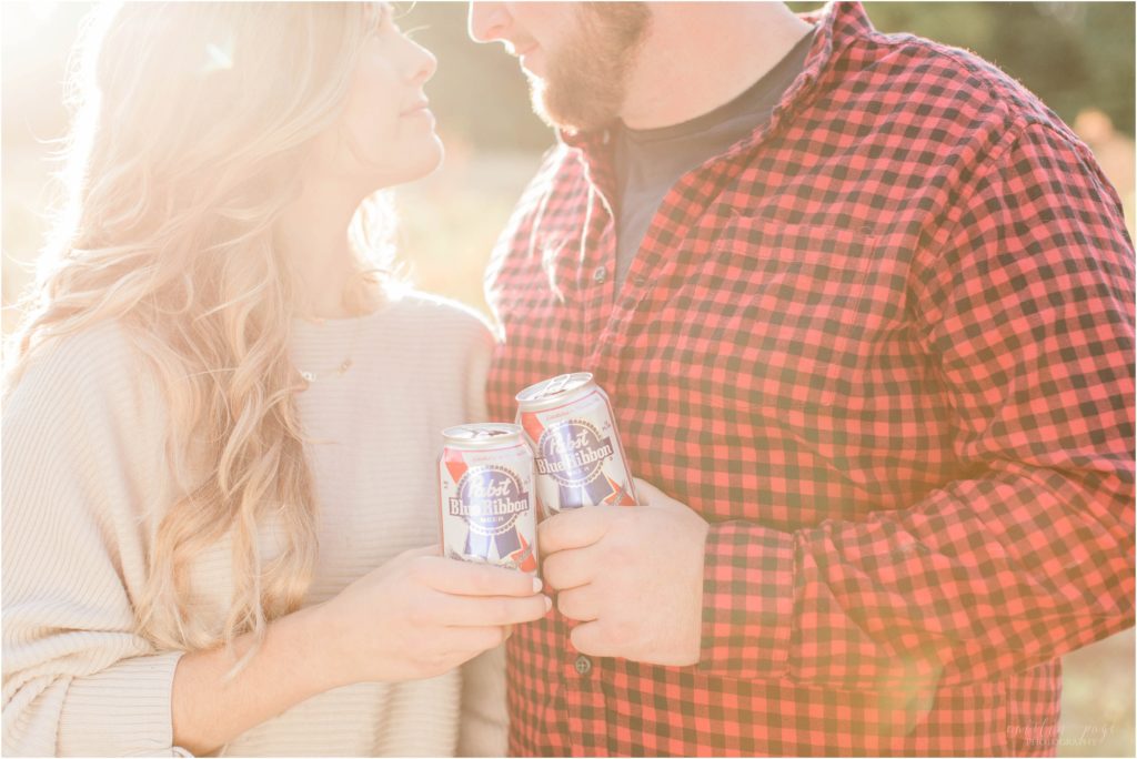 couple toasting with pbr cans