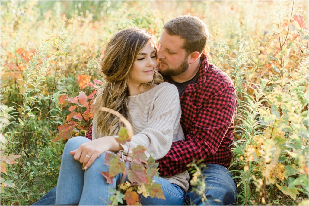 couple together in field new hampshire engagement session