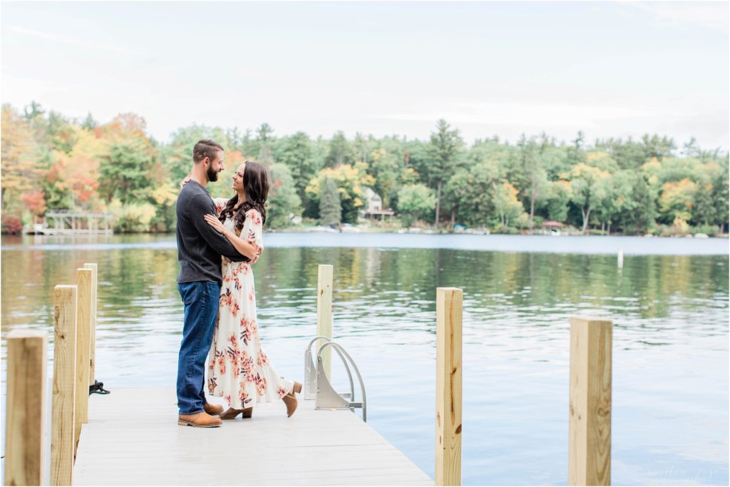 couple standing on dock lake winnipesaukee new hampshire
