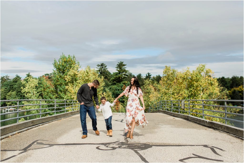 family walking on bridge lake winnipesaukee nh