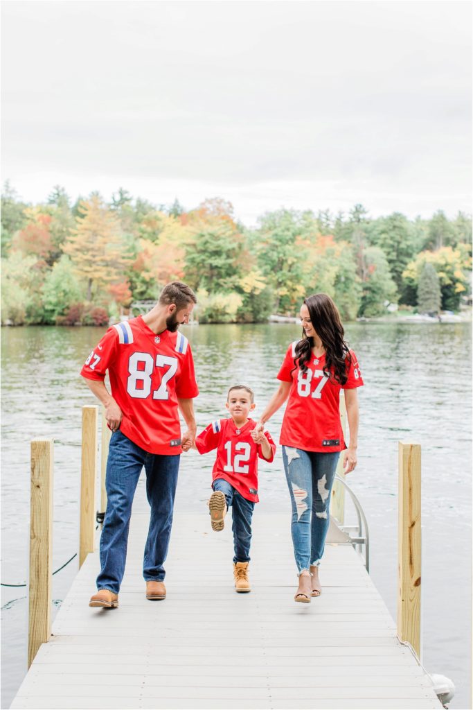 family walking on dock in patriots jerseys