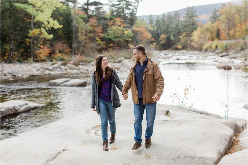 couple walking on rocks at lower falls new hampshire