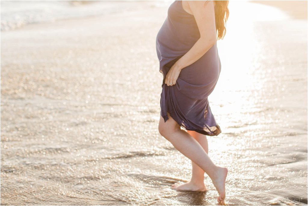 pregnant woman walking into ocean