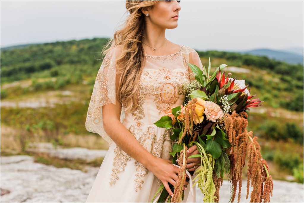 woman holding bouquet on mountain