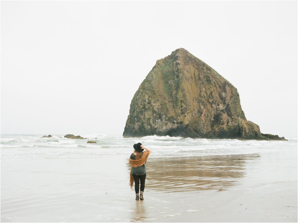woman standing at cannon beach oregon