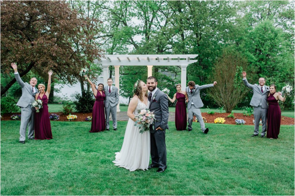 bride and groom kissing bridal party