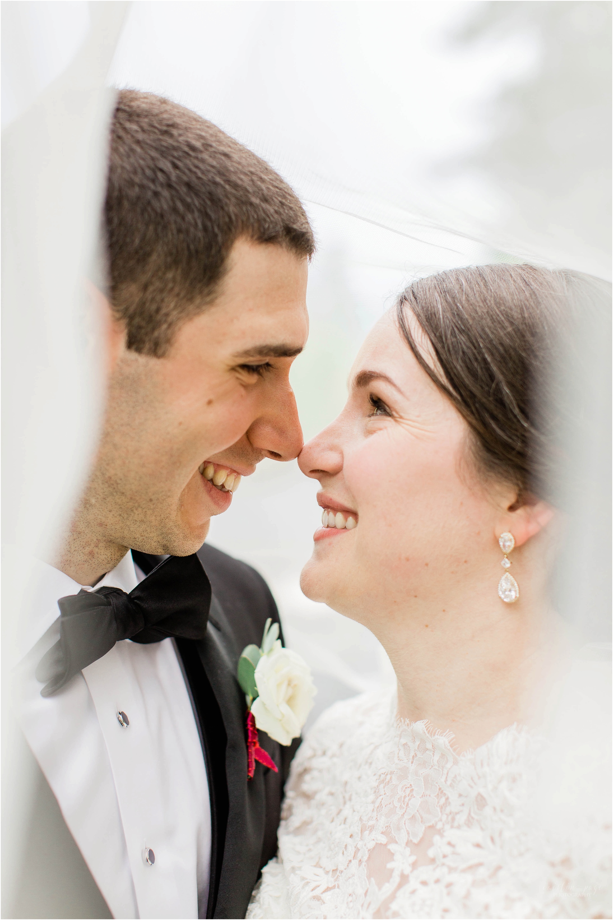 bride and groom under wedding veil