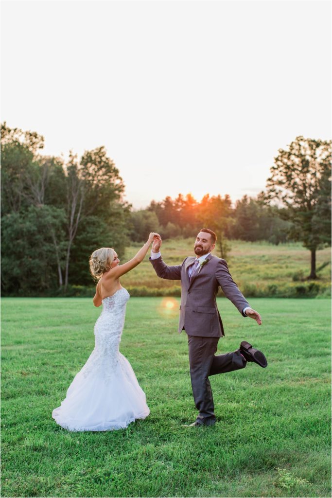 bride and groom dancing at sunset