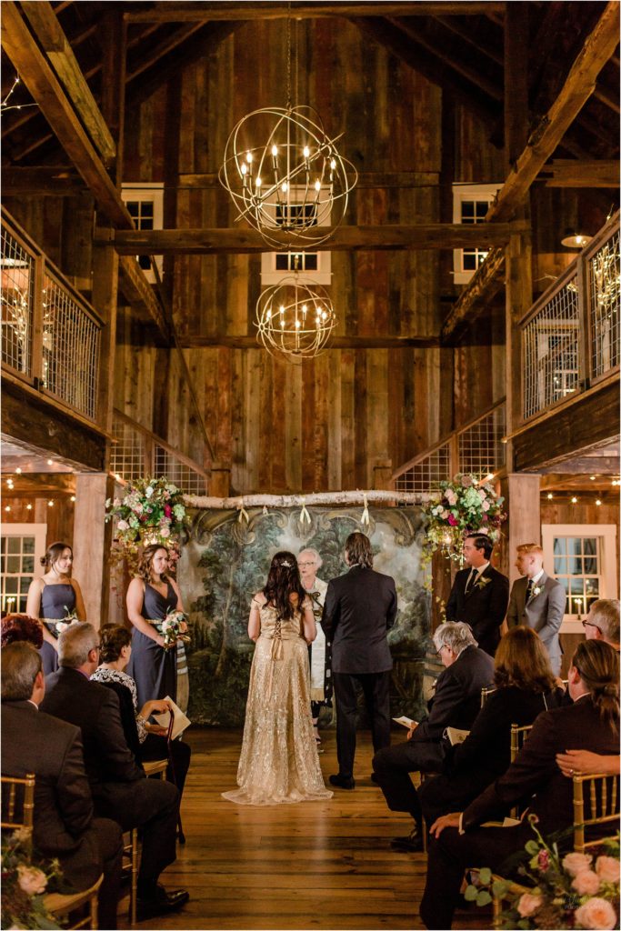bride and groom during wedding ceremony barn