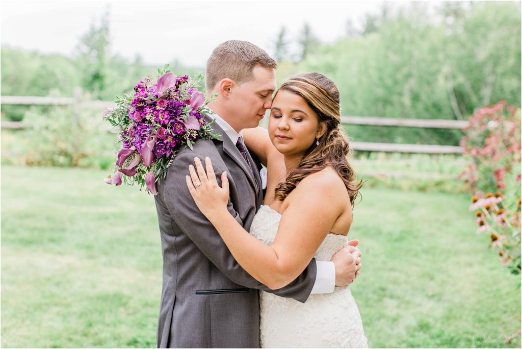 couple snuggled together purple bouquet