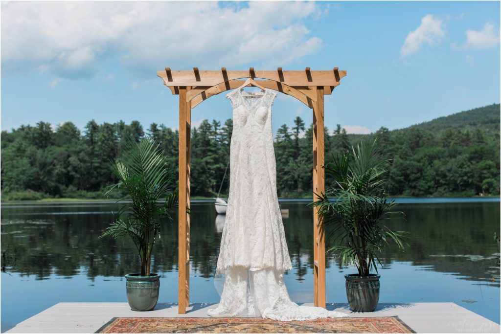 wedding dress hanging by lake