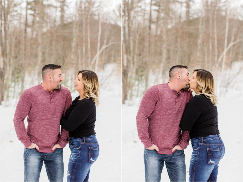 man and woman kissing snow