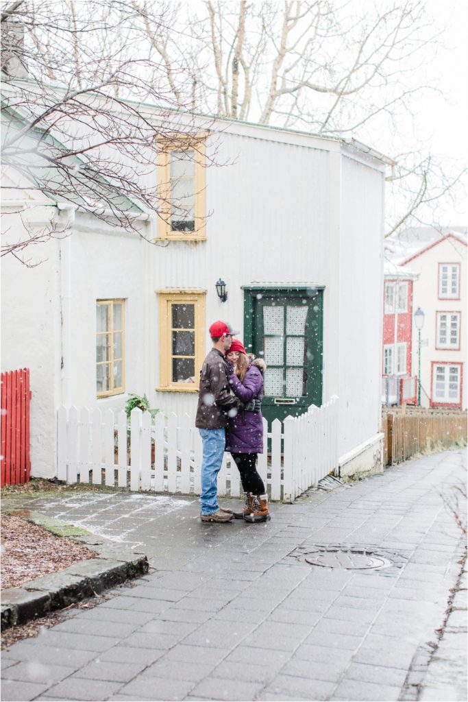 couple standing in front of house in iceland