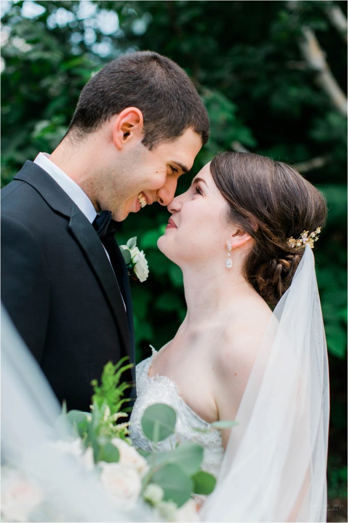 bride and groom looking at each other with long veil