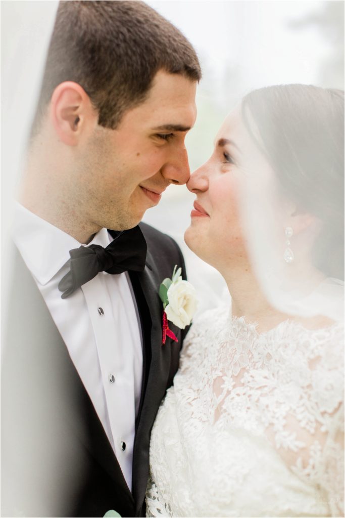 bride and groom under wedding veil jackson new hampshire