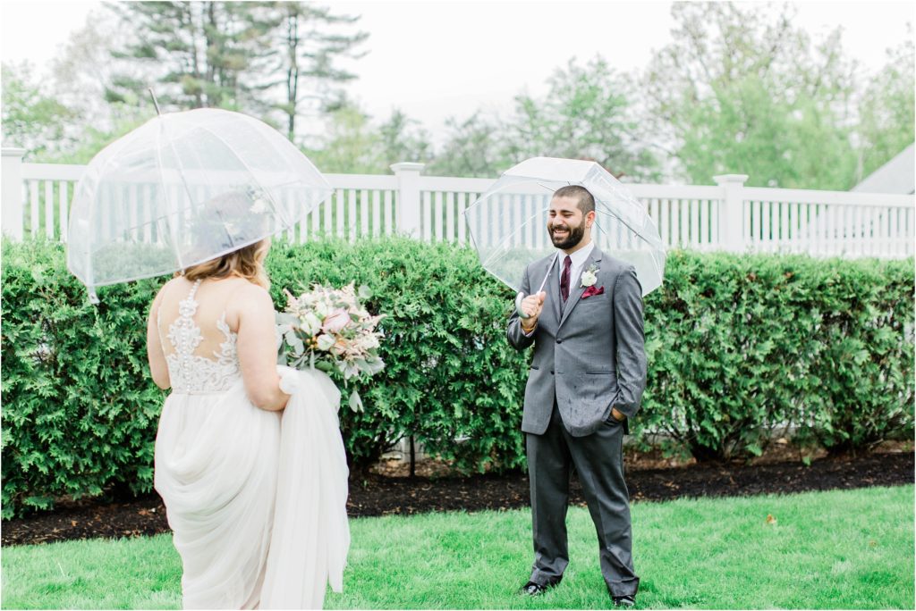man seeing woman at first look with umbrellas rainy wedding day