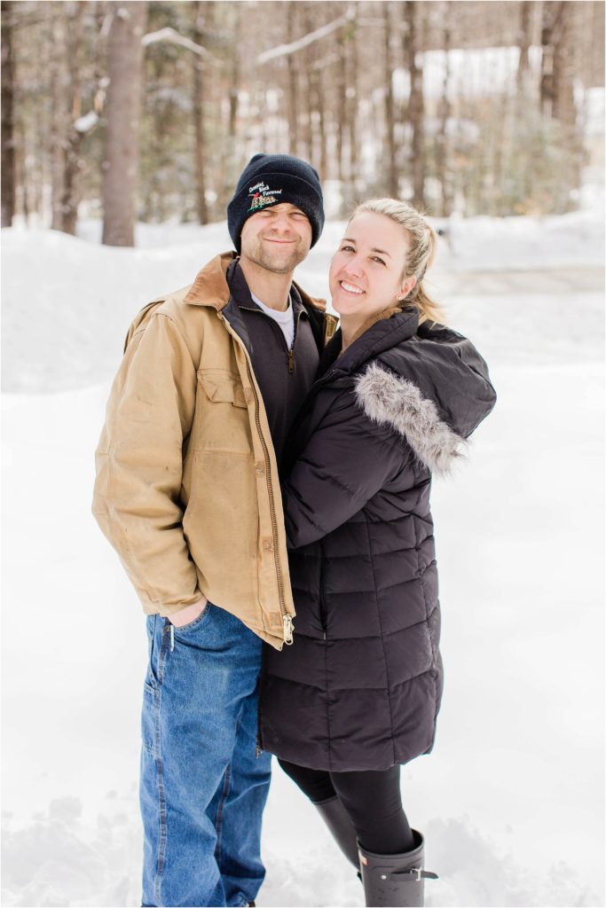 man and woman standing in the snow