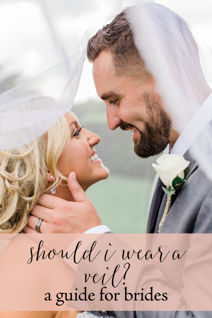man and woman under wedding veil