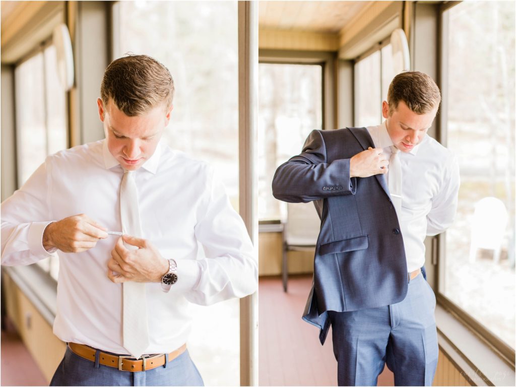 man putting on a suit jacket