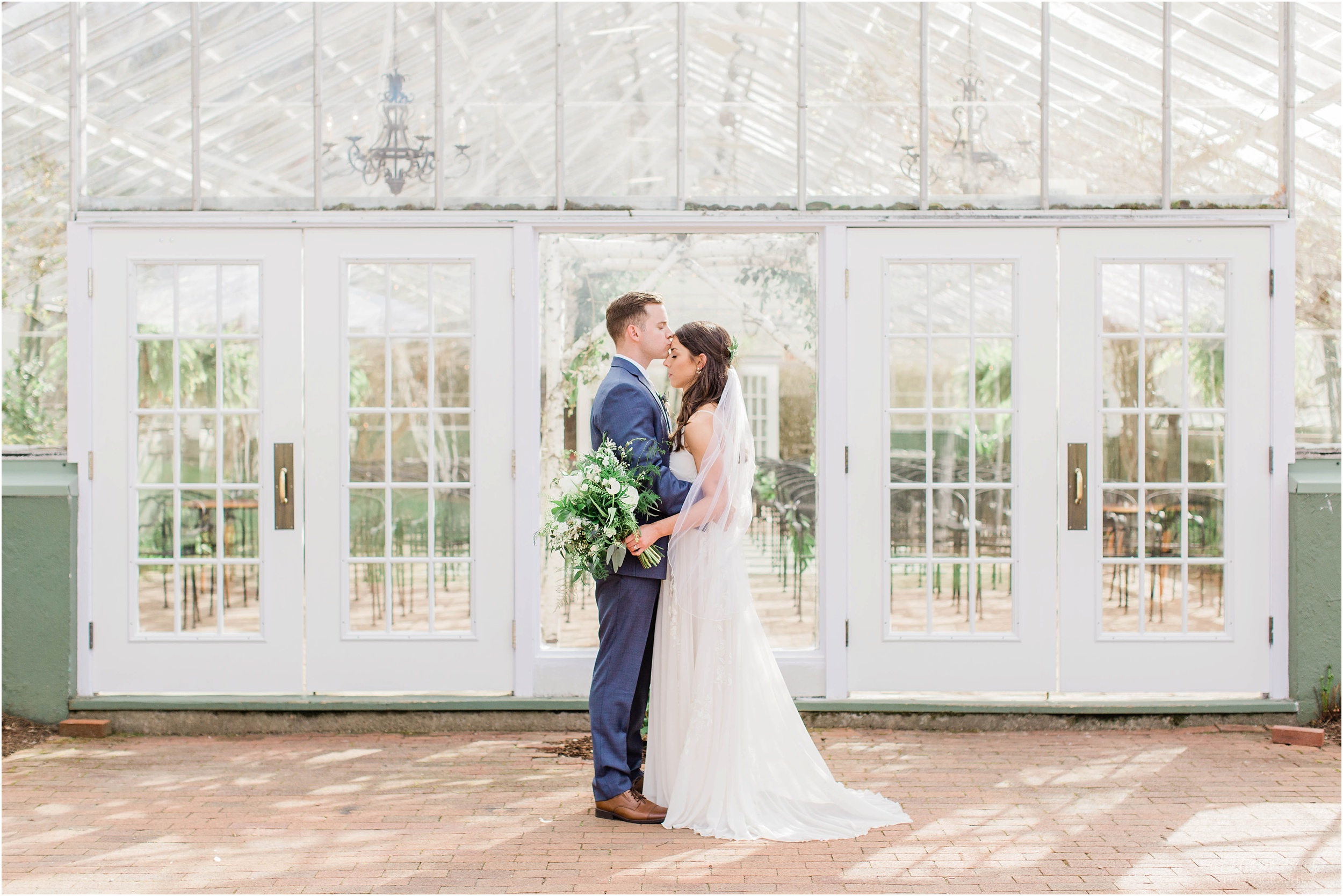 bride and groom standing outside the greenhouse