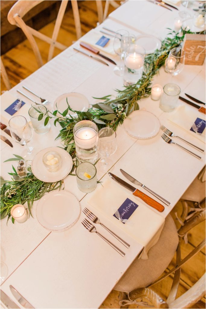 simple table setting at wedding reception with greenery